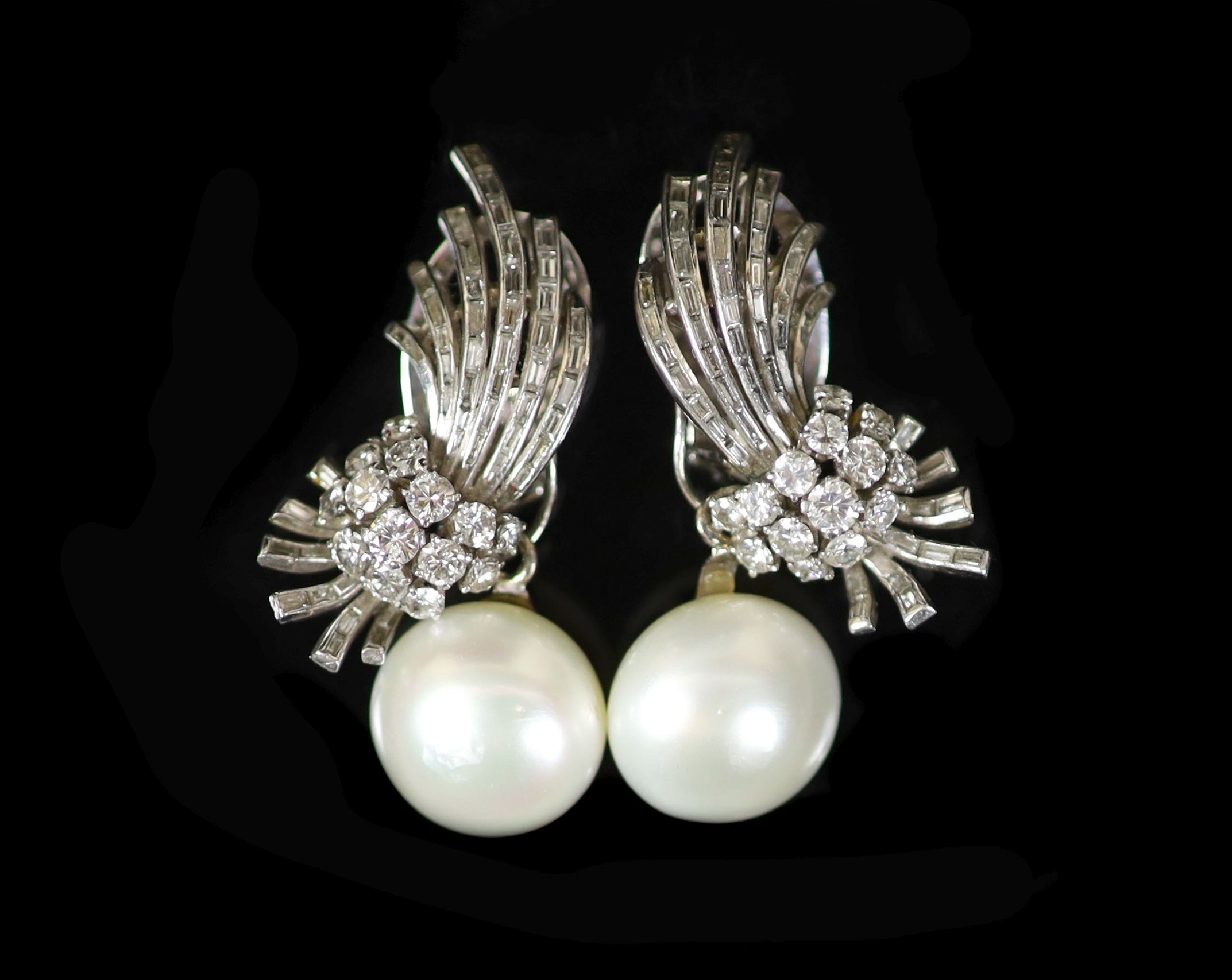 A pair of platinum, pearl and round and baguette cut diamond set spray drop ear clips